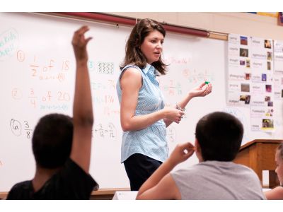 Volunteer working with students