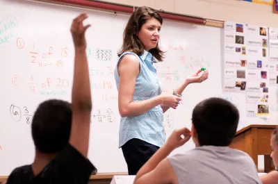 Volunteer working with students
